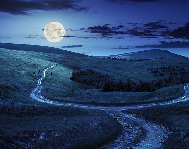istock cross road on hillside meadow in mountain  at night 531147407
