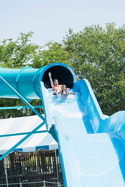 istock Mother and daughter on water slide 531148995