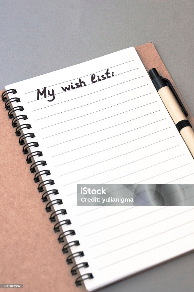 Hand drawing wish list on notebook Hand drawing wish list on notebook from recycling paper on grey background with handle 2015 Stock Photo