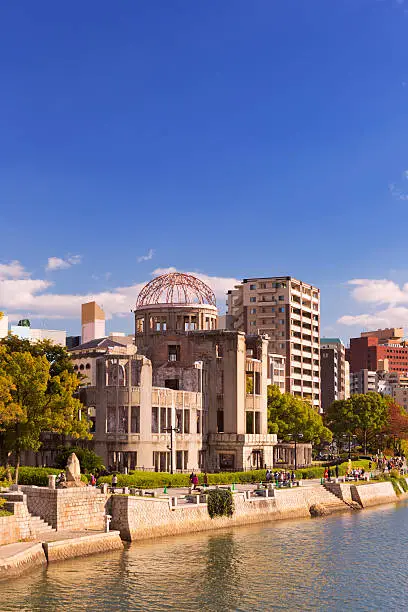 The Atomic Bomb Dome along the river in Hiroshima on a sunny afternoon in autumn.