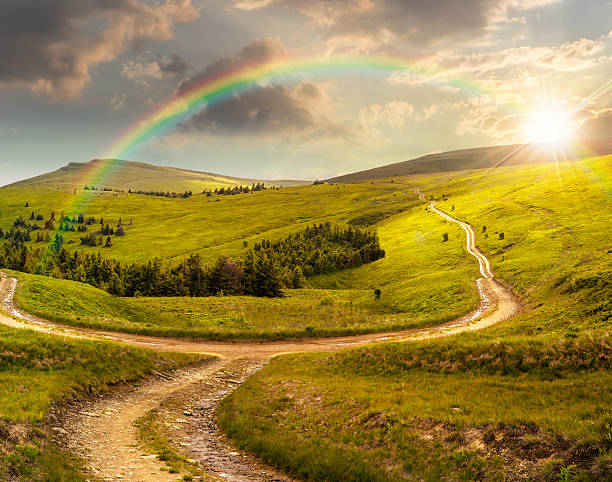 istock cross road on hillside meadow in mountain at sunset 531150451