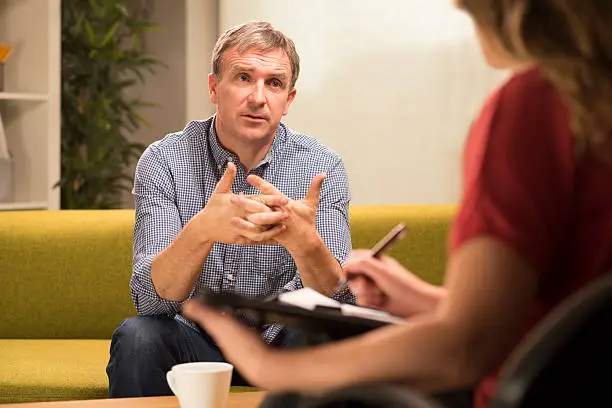 mature man in therapy explains to therapist