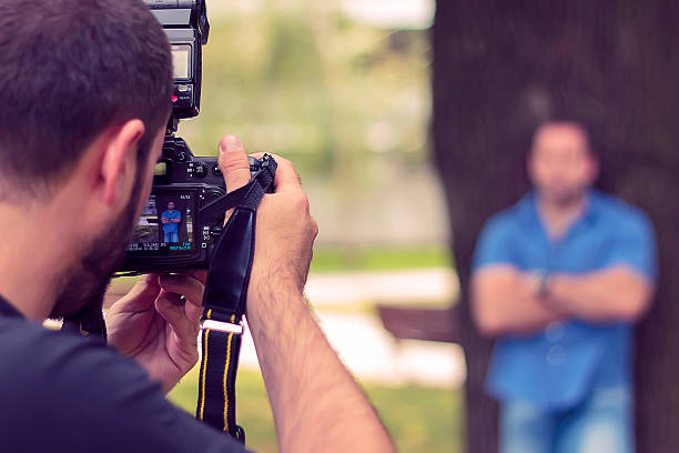 istock Photographer taking a picture of a man 531152087