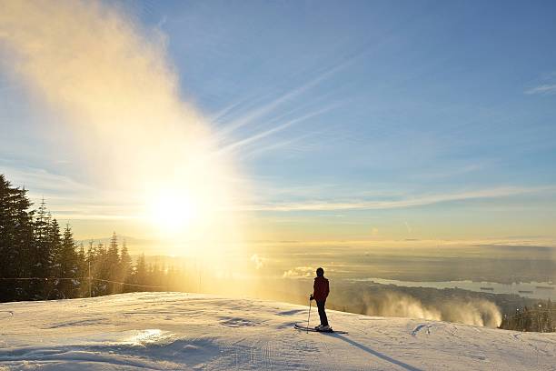 Lady Skier enjoy sunrise on Grouse Mountain stock photo