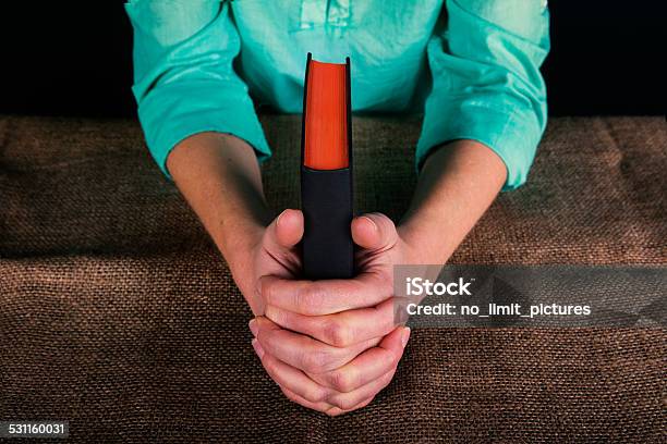 Hands Folded Together Holding A Bible Stock Photo - Download Image Now - 2015, Adult, Adults Only