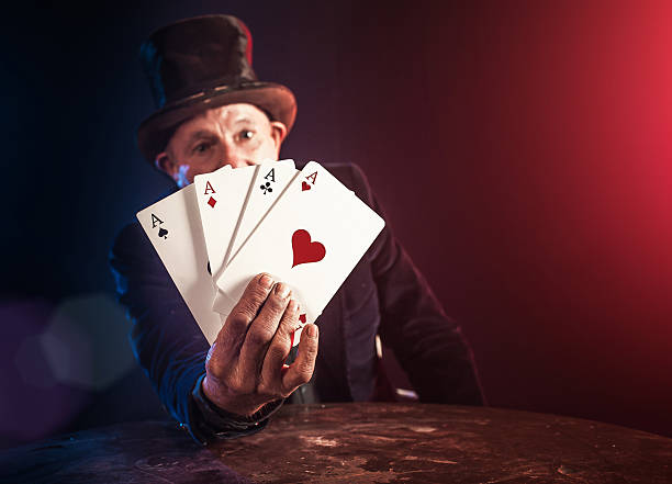 istock Senior man making trick with playing cards 531160107