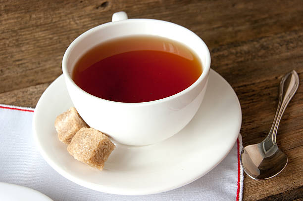 istock Cup of tea with sugar cubes and cake 531163171
