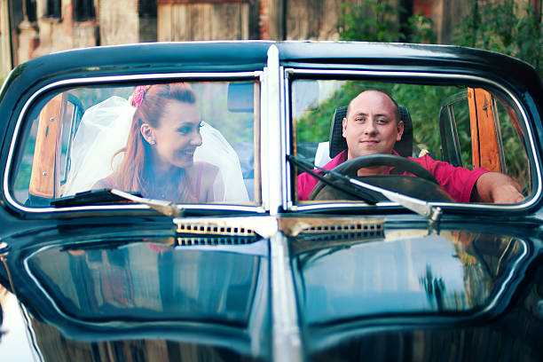 istock bride and groom in a retro car 531163273