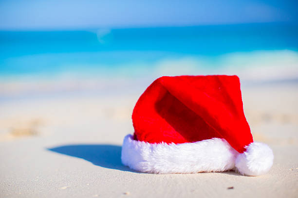 istock Close up Santa hat on a white sandy beach 531163739
