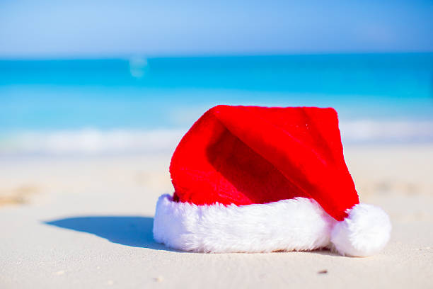 istock Close up Santa hat on a white sandy beach 531163741
