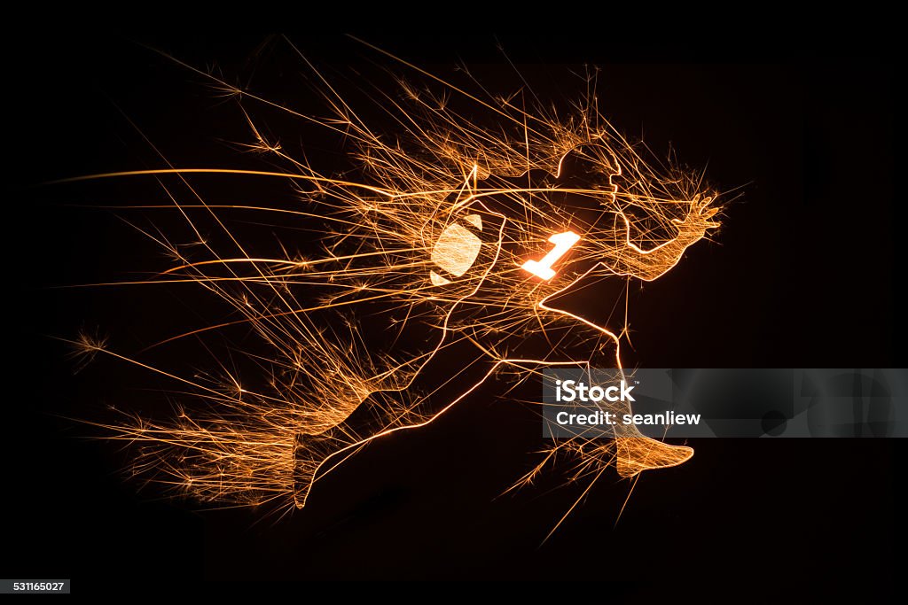 Football player running with ball on black background Sparkly design of football player holding ball in running action on black background with copy space. Activity Stock Photo