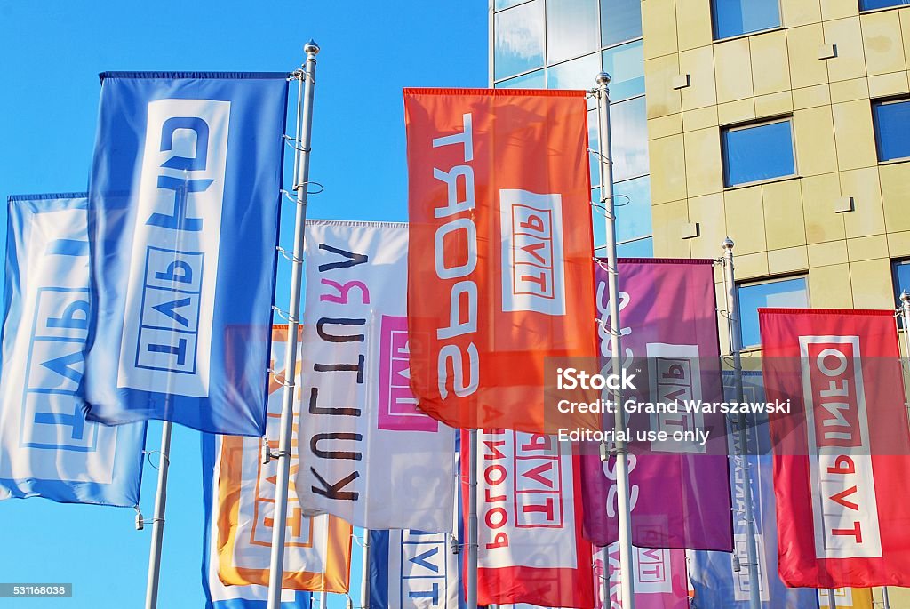 Flags flapping in the new headquarters of TVP in Warsaw. Warsaw,Poland. - May 10, 2016: Warsaw, Poland, May 2016. flags under the building TVP in Warsaw. Flag Stock Photo