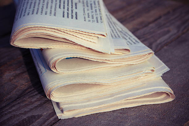 istock Newspapers on old wood background. Toned image. 531173663