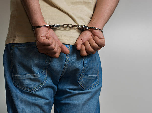 istock Adult male arrested and handcuffed 531174140