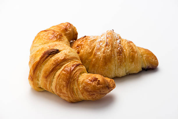istock fresh and tasty croissants, isolated on white background. 531174877