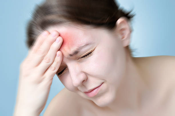 istock Young woman touching her head 531174894