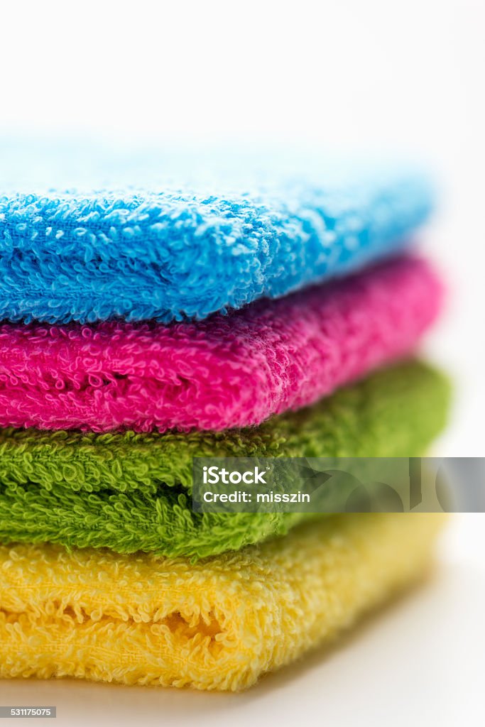colorful towels, stacked, isolated colorful, stacked bathroom towels, isolated on a white background, close up 2015 Stock Photo