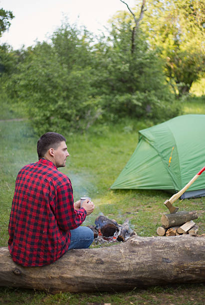 istock Camping tent and a bonfire in the woods. 531175452