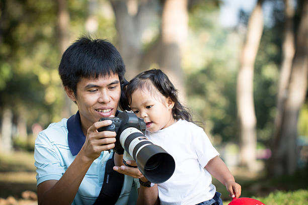 istock Father and daughter looking picture on camera 531175705