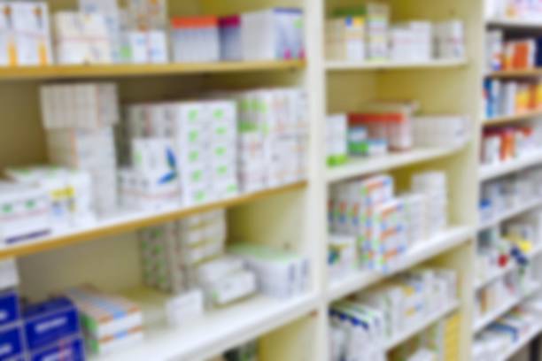 istock Pharmacy store drugs shelves interior blurred background 531176966