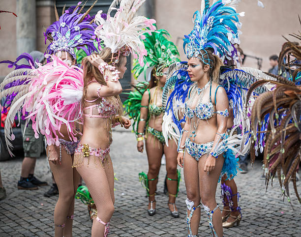 Young women parading in the Copenhagen Whitsun Carnival, 2016. Copenhagen, Denmark - May 14, 2016: Young women in beautiful costumes ready to enter the parade in the Copenhagen Whitsun Carnival, 2016. whitsun stock pictures, royalty-free photos & images