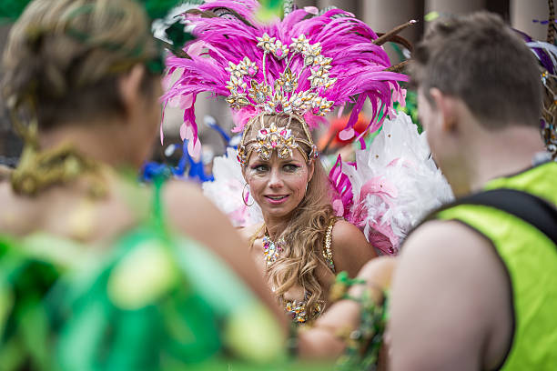 Young woman parading in the Copenhagen Whitsun Carnival, 2016. Copenhagen, Denmark - May 14, 2016: Young woman in beautiful costume ready to enter the parade in the Copenhagen Whitsun Carnival, 2016. whitsun stock pictures, royalty-free photos & images