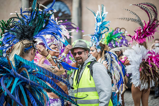 Getting a feather in the cap, Copenhagen Whitsun Carnival, 2016 Copenhagen, Denmark - May 14, 2016: Lucky man getting a feather in the cap during the Copenhagen Whitsun Canival, 2016. whitsun stock pictures, royalty-free photos & images