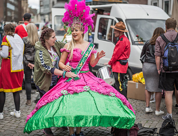 Young woman parading in the Copenhagen Whitsun Carnival, 2016. Copenhagen, Denmark - May 14, 2016: Young woman in beautiful costume ready to enter the parade in the Copenhagen Whitsun Carnival, 2016. whitsun stock pictures, royalty-free photos & images