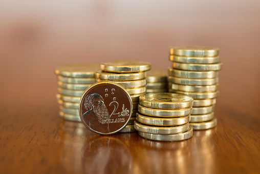 Stack of Australian two dollar coins on a timber background