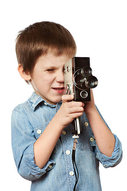 istock Little boy cameraman filming with retro camera 531178459