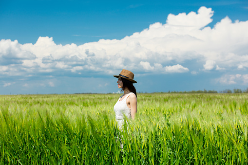 portrait of the beautiful young woman standing in the field