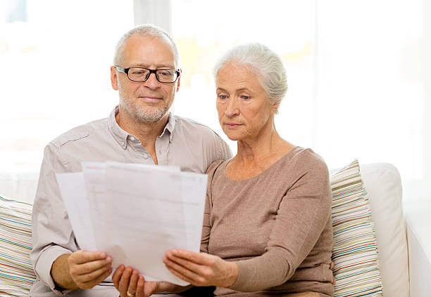 istock senior couple with papers at home 531178925