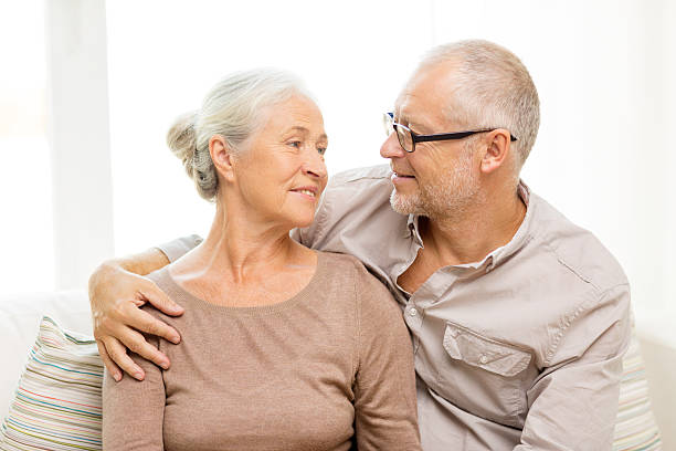 istock happy senior couple hugging on sofa at home 531178973