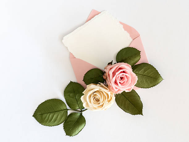 istock Pink envelop with white card and roses. Flat lay 531179068