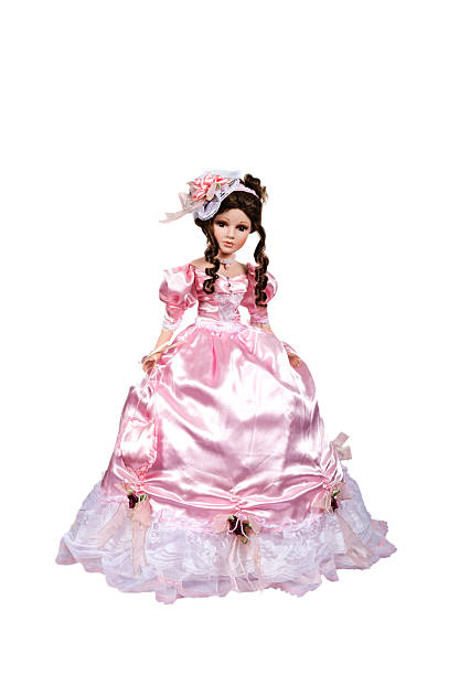 istock doll dressed in pink dress and hat isolated over white 531179777