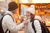 Couple on Christmas Market in Ljubljana Eating Crepes