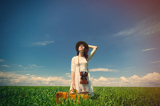 istock young woman with suitcase and camera 531180122