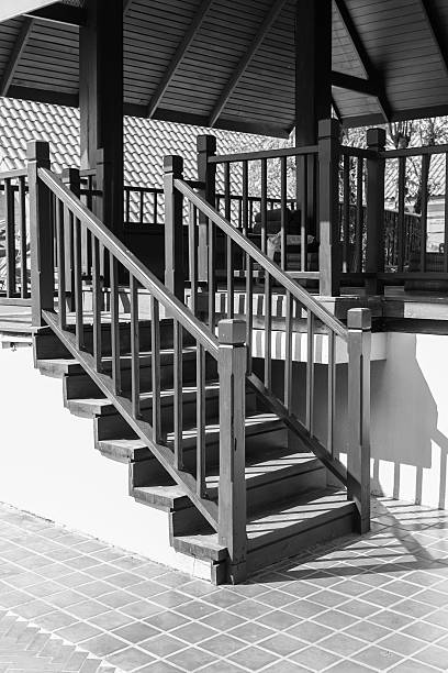 shadow of the bannister on wooden stair step