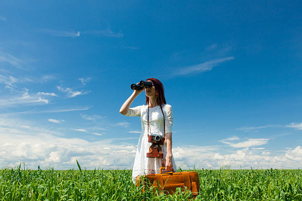 istock young woman with suitcase and binocular 531180730
