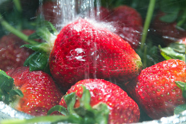 Strawberries Being Rinsed Under Running Water Pic 2 Of 2