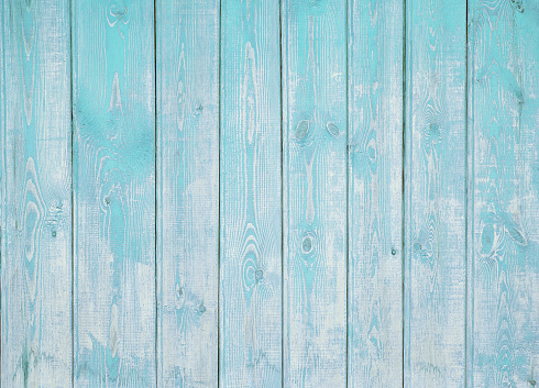 Background of the old wooden vertical boards with peeling blue paint, texture