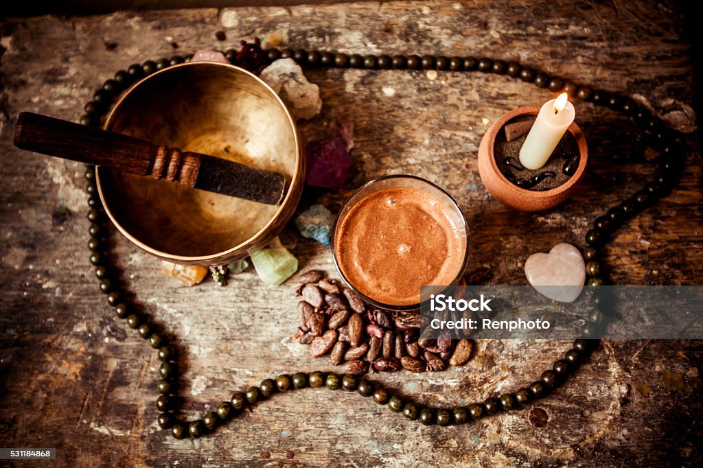 Cacao Beverage, Tibetan Singing Bowl and Gemstones Cacao Beverage, Tibetan Singing Bowl, candle  and Gemstones Ceremony Stock Photo