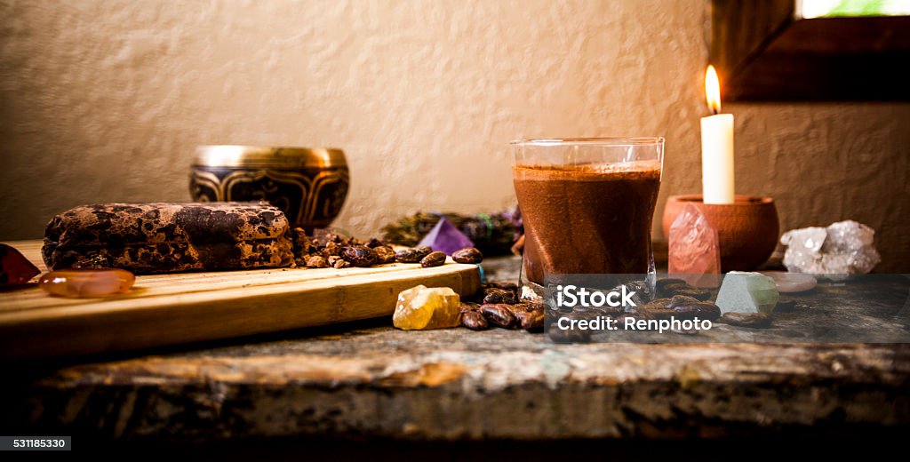 Ceremonial Cacao Beverage (Raw Chocolate) Ceremonial Cacao Beverage (Raw Chocolate), surrounded by ingredients, gemstones, a Tibetan singing bowl and candle. Cacao Fruit Stock Photo