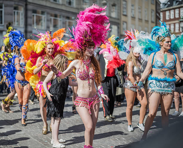 Young women parading in the Copenhagen Whitsun Carnival, 2016. Copenhagen, Denmark - May 14, 2016: Young women in beautiful colorful costumes parading in the Copenhagen Whitsun Carnival, 2016. whitsun stock pictures, royalty-free photos & images