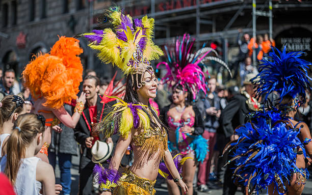 Young woman parading in the Copenhagen Whitsun Carnival, 2016. Copenhagen, Denmark - May 14, 2016: Young woman in beautiful costume parading with others in the Copenhagen Whitsun Carnival, 2016. whitsun stock pictures, royalty-free photos & images