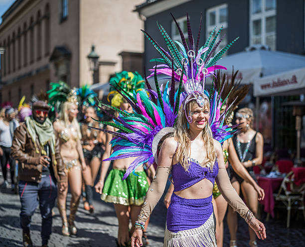 Young women parading in the Copenhagen Whitsun Carnival, 2016. Copenhagen, Denmark - May 14, 2016: Young women in beautiful costumes ready to enter the parade in the Copenhagen Whitsun Carnival, 2016. whitsun stock pictures, royalty-free photos & images