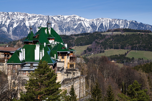 The Sudbahnhotel (Südbahnhotel) at Semmering, Lower Austria, against snow-covered Rax, a mountain in Lower Austria. The Sudbahnhotel, built in 1881, was a famous Grand Hotel and summer resort