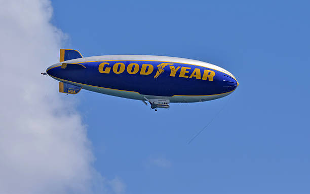 Palm Beach, Florida, USA - September 23, 2012: The Goodyear Blimp makes its way across the Atlantic shore just after sunrise as a thunderstorm builds on the horizon. Shot was taken from the 20th floor of a building to capture the eye-level view of the Blimp.