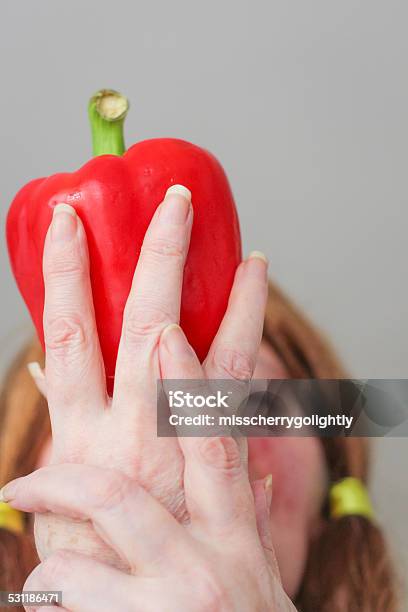 Red Pepper And Hands Covering Womans Face Stock Photo - Download Image Now - 2015, Adult, Apple - Fruit