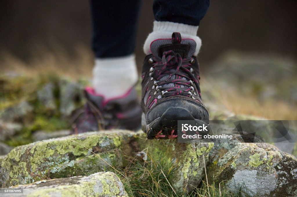 Mountain Trekking Boots Close up of a female trekking a mountain with a pink design on her walking boots Hiking Boot Stock Photo